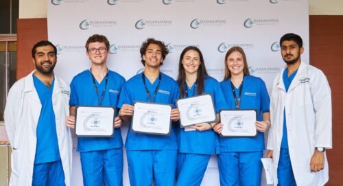 A group of people in blue scrubs holding certificates, possibly signifying a medical internship in Kenya.