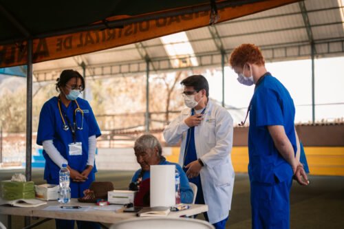 Medical team attending to a patient in a makeshift clinic. Likely related to a medical internship in Peru.