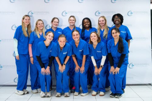 A group of people is wearing matching blue scrubs, possibly related to a medical internship in Peru.